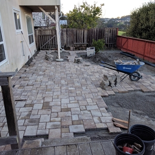 Concrete pavers being laid down.
